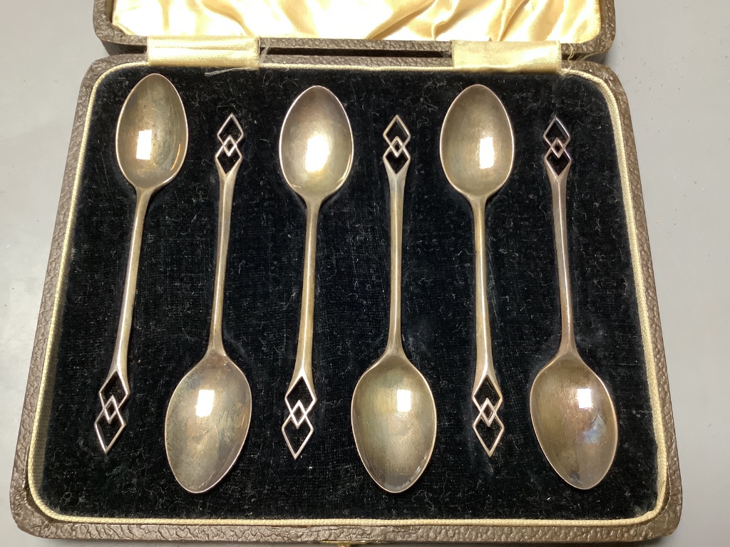 Three cased sets including silver teaspoons, a silver toast rack, three silver napkin rings and a quantity of minor silver flatware.